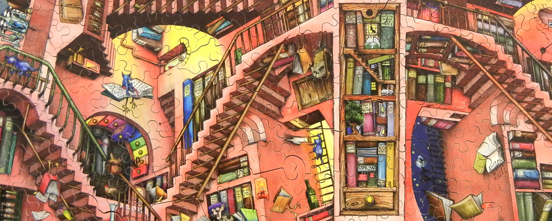 Wooden jigsaw graduation puzzle featuring a magical library. The books have hands & feet and are running around the libary.